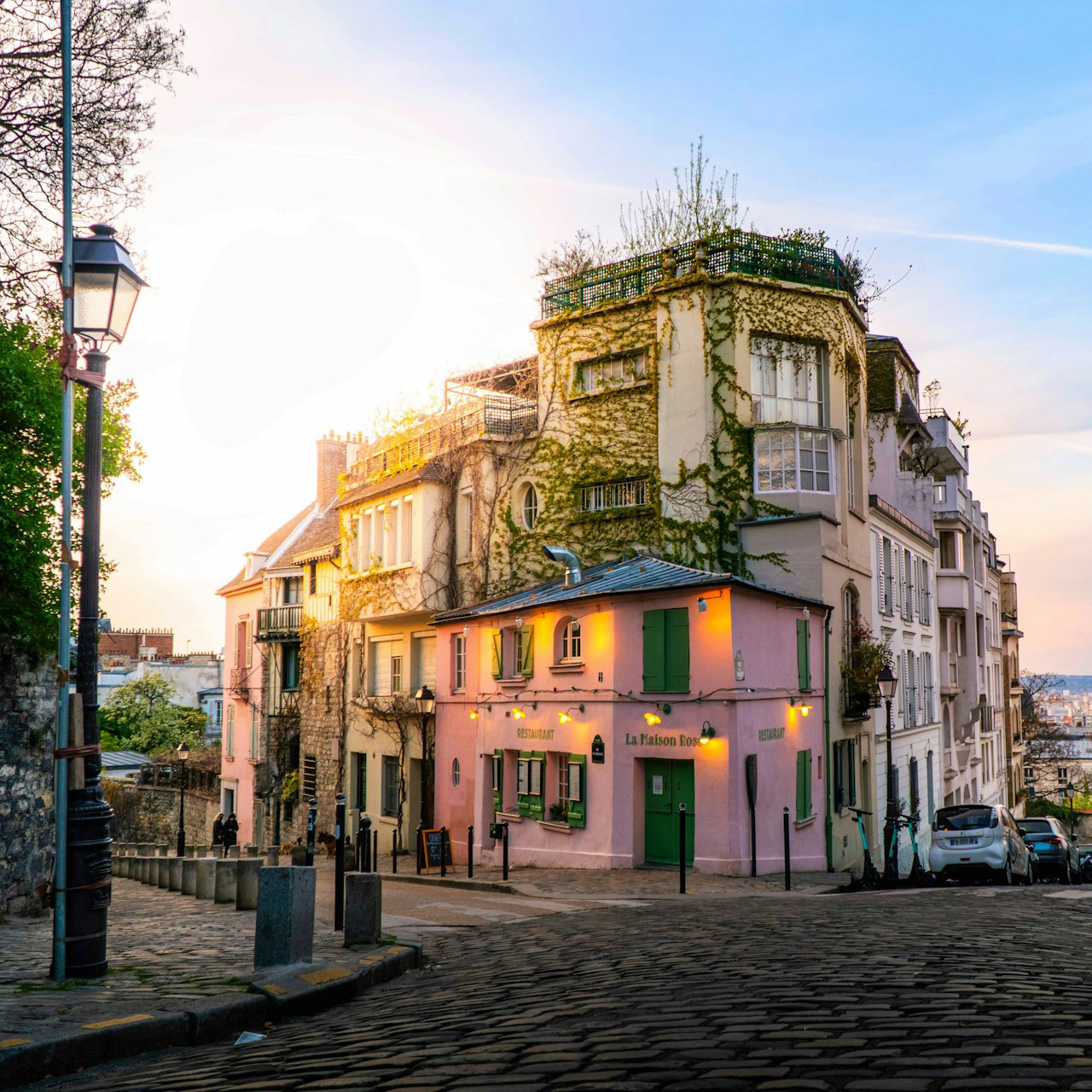 A cobbled Montmartre corner in Paris at dawn, empty of people
