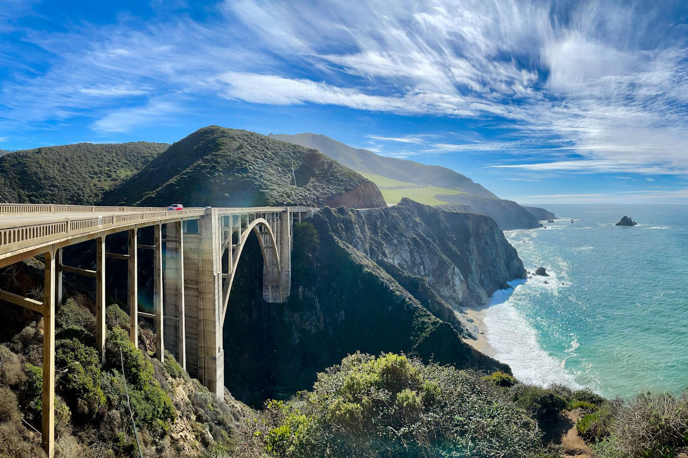 The Bixby Bridge on the Big Sur coast above green cliffs and surf
