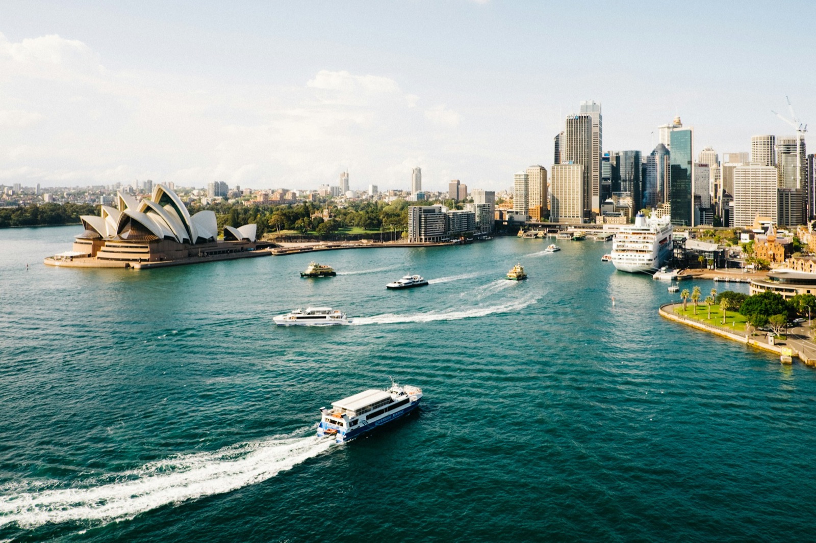 Ferries crossing Sydney Harbour past the Opera House and the city