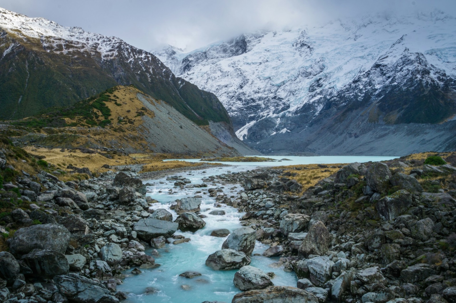 A glacial river running out of a snow valley in the Southern Alps