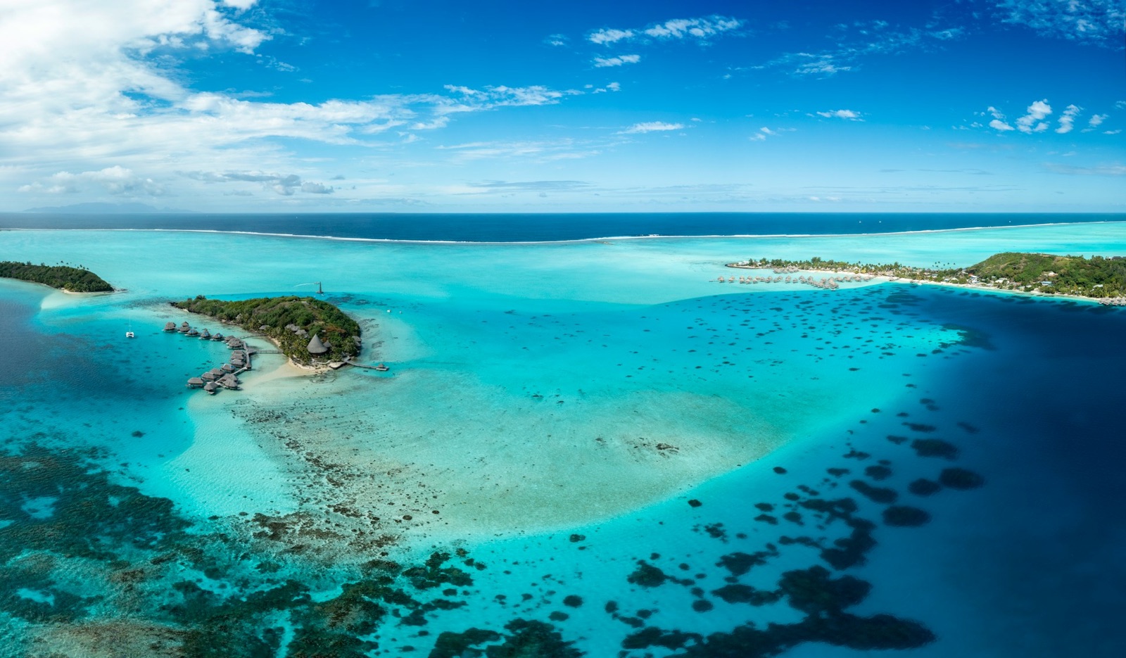 A turquoise lagoon and motu seen from the air in French Polynesia
