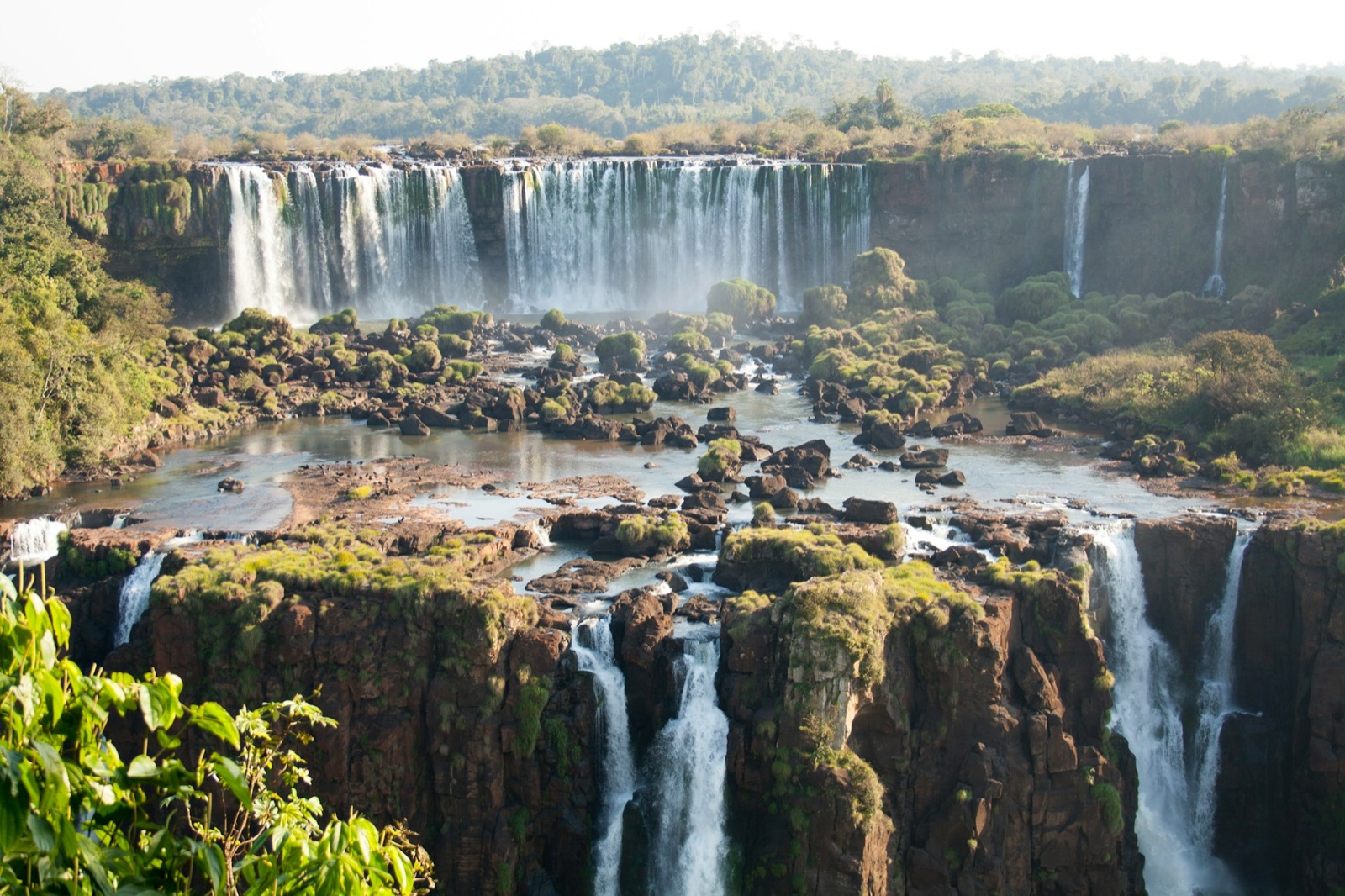 The tiered falls at Iguazu spilling through green forest